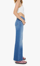 Load image into Gallery viewer, Woman standing, side view, wearing Mother Denim The Roller Fray jeans, in colour Work Hard Play Hard, available at Amara Home.
