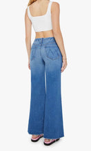 Load image into Gallery viewer, Woman standing, back view, wearing Mother Denim The Roller Fray jeans, in colour Work Hard Play Hard, available at Amara Home.